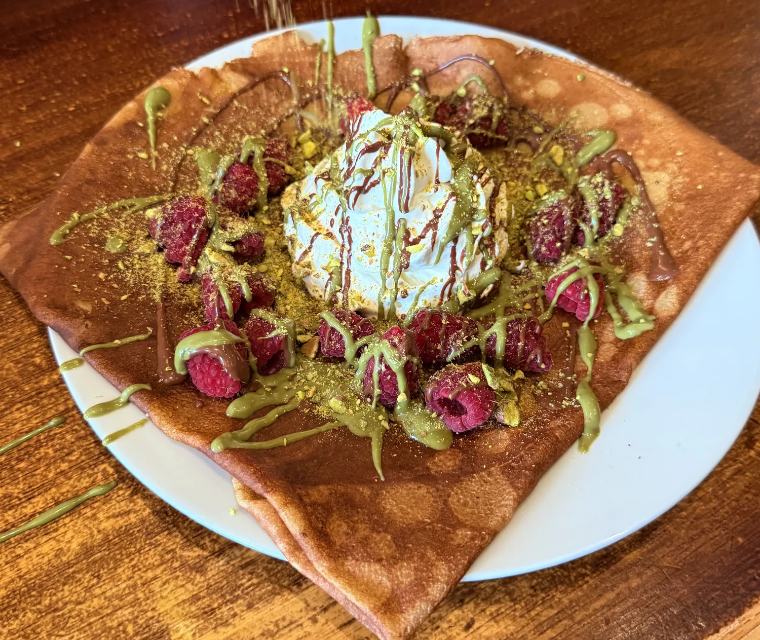 A sweet crêpe with raspberries, pistachio cream and Chantilly at Paris Crêpes Café, Niagara Falls